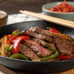Steak and Pepper Stir Fry served in a black bowl