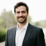 Portrait of Nicolas, co-founder of My Recipes Made, smiling in a suit with a natural bright background