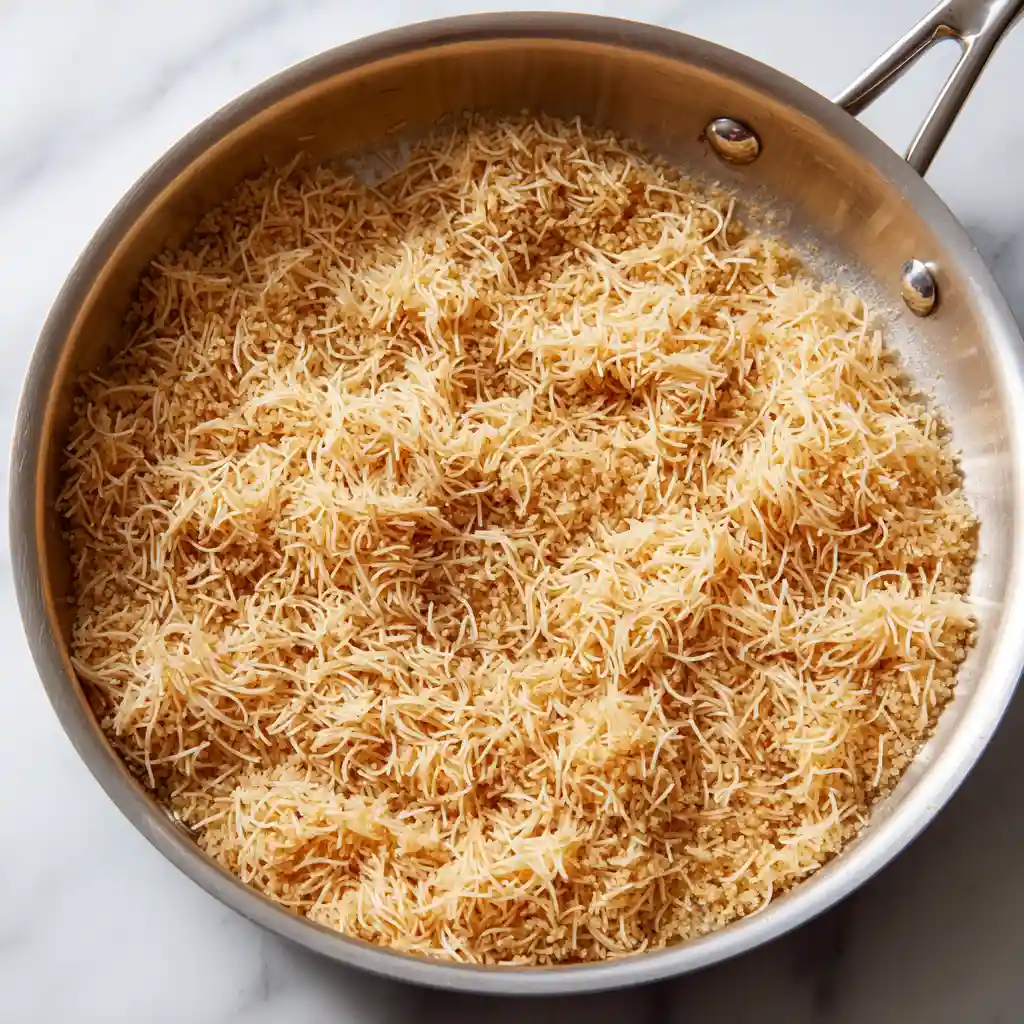 Turkish Bulgur Pilaf step 2 with medium bulgur mixed with golden toasted vermicelli for a brief dry toast, no liquid or hands